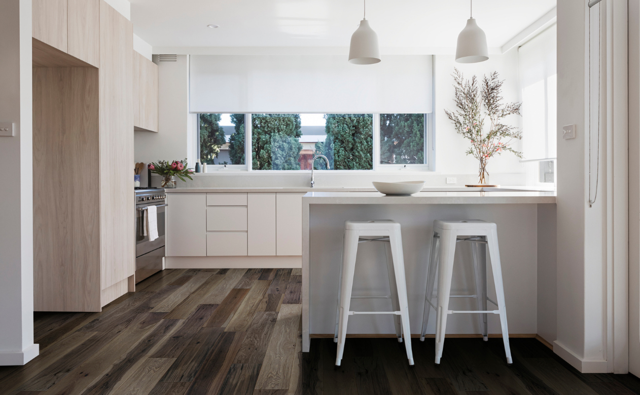 Kitchen with dark hardwood and white shades